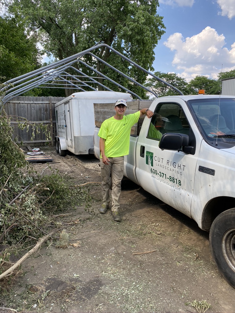 Brendan Lockerby in front of a Cut Right Landscaping truck and trailer, circa the early years before the 2025 rebrand to Polaris Landscape.